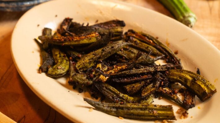An oval plate filled with roasted okra