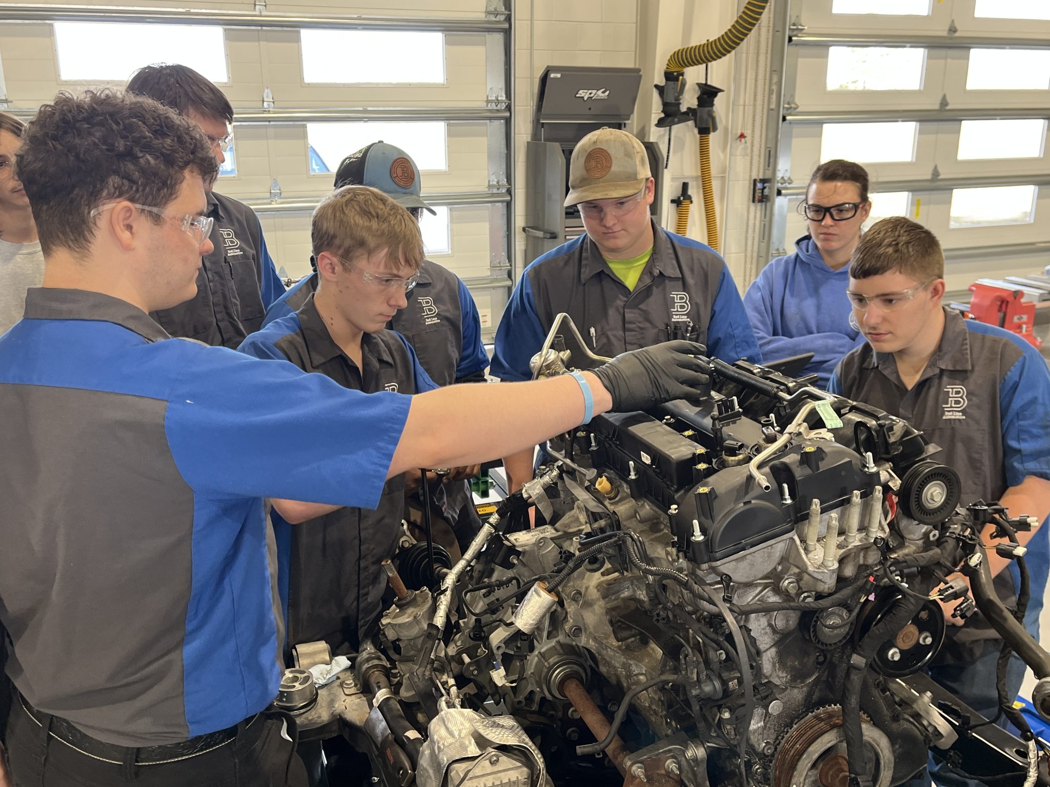 Students work on a car engine at Baldwin Preparatory Academy in Loxley, Ala., on Jan. 9, 2026. (Trisha Crain | Alabama Daily News)